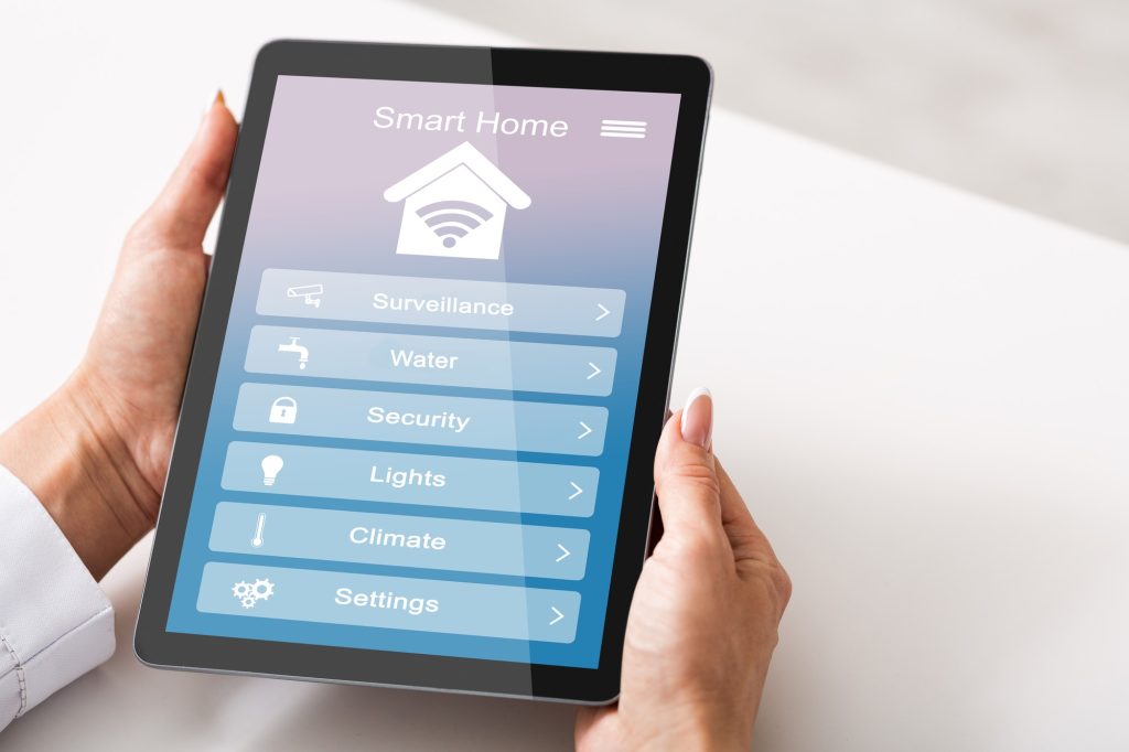 Remote Smart Home Control System Opened On Digital Tablet In Female Hands