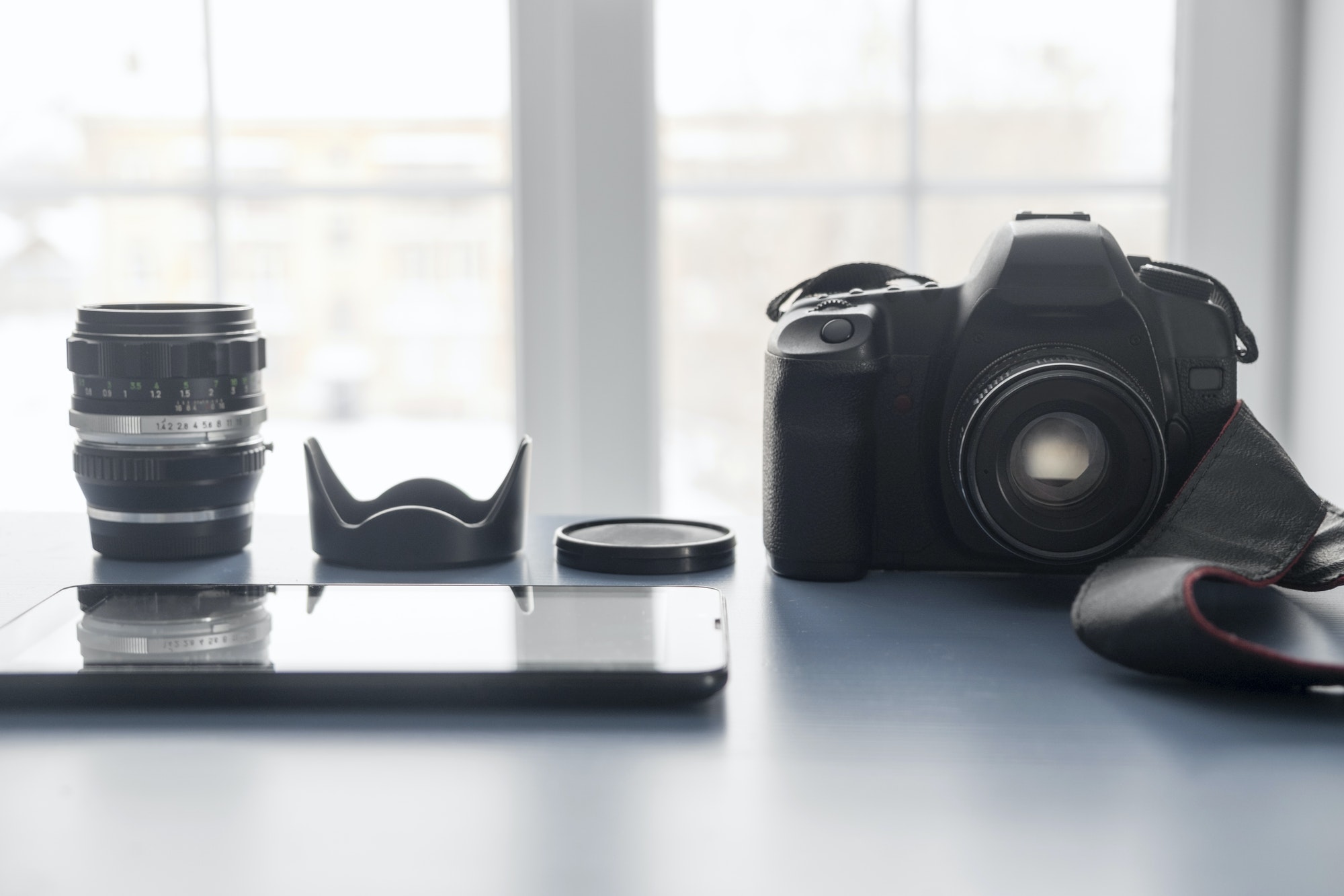 Digital tablet and digital SLR camera on studio desk